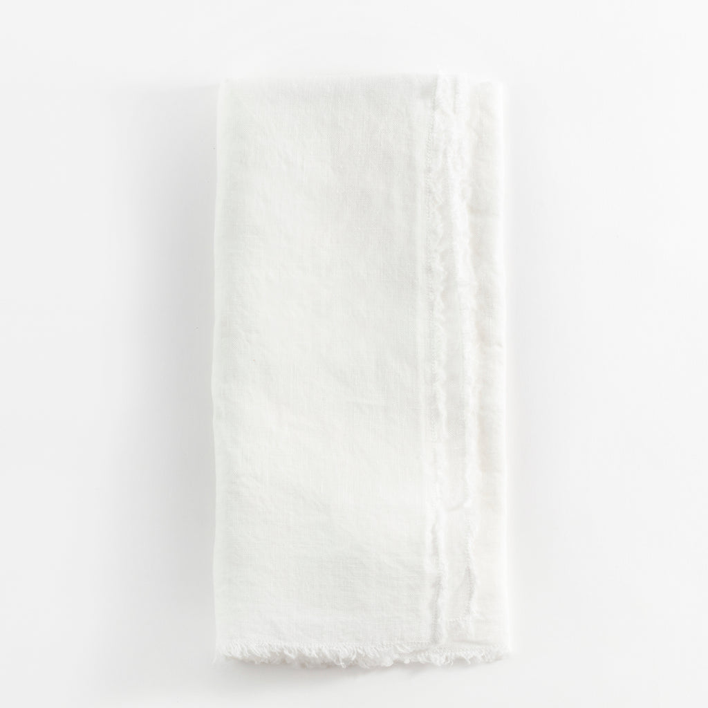 Soft, textured white fabric with a casual, frayed edge.