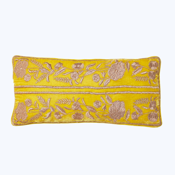 Vibrant yellow pillow with intricate floral embroidery in contrasting tones.