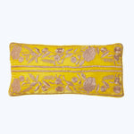 Vibrant yellow pillow with intricate floral embroidery in contrasting tones.