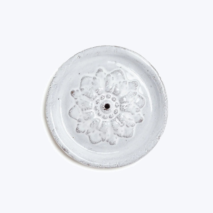 Hand-crafted flower frog with floral design on translucent glass material.