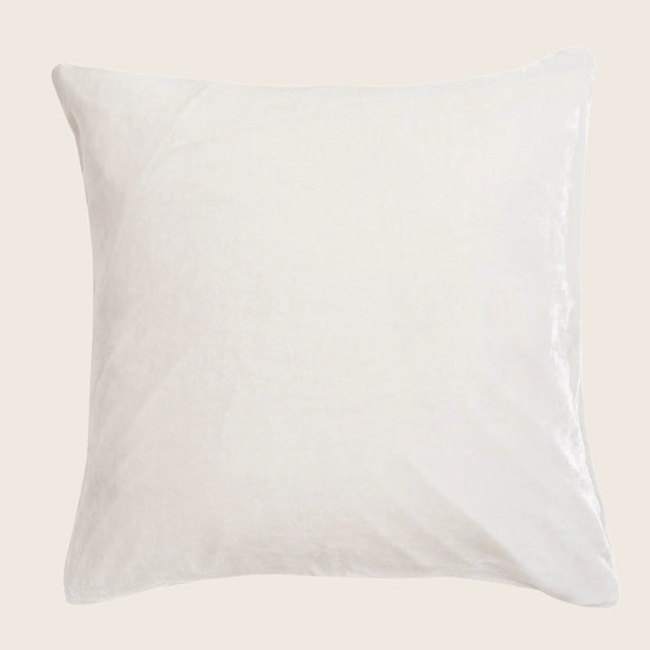 Plain white pillow with a soft texture, creating a monochromatic look.