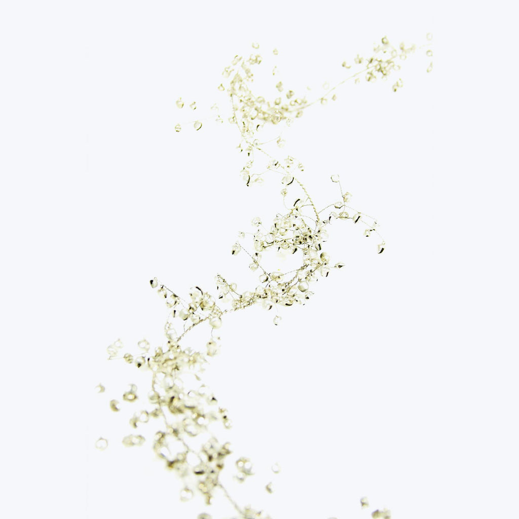 Intricate network of delicate beads on white background, elegant design.