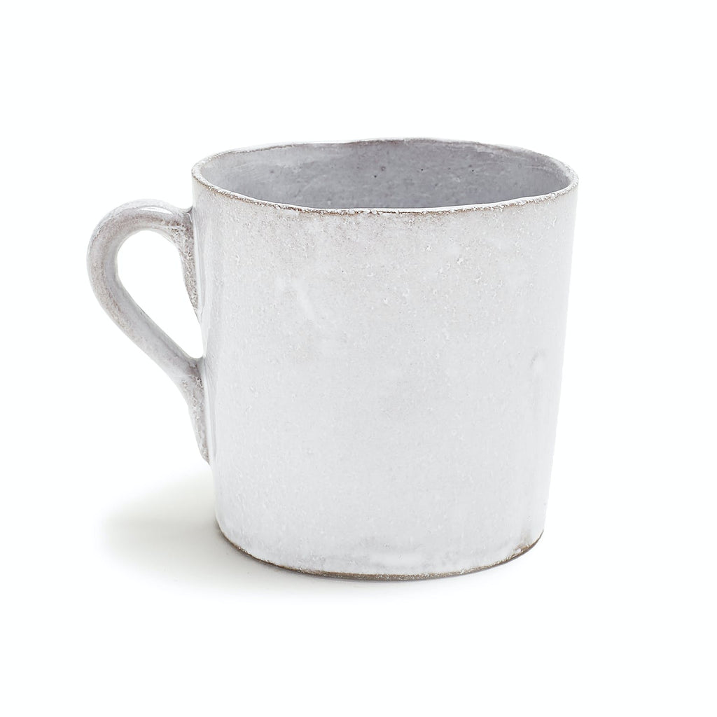 Rustic white ceramic mug with worn rim embodies minimalist charm.