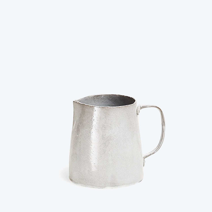 Simple, metallic pitcher with utilitarian design on plain white background.