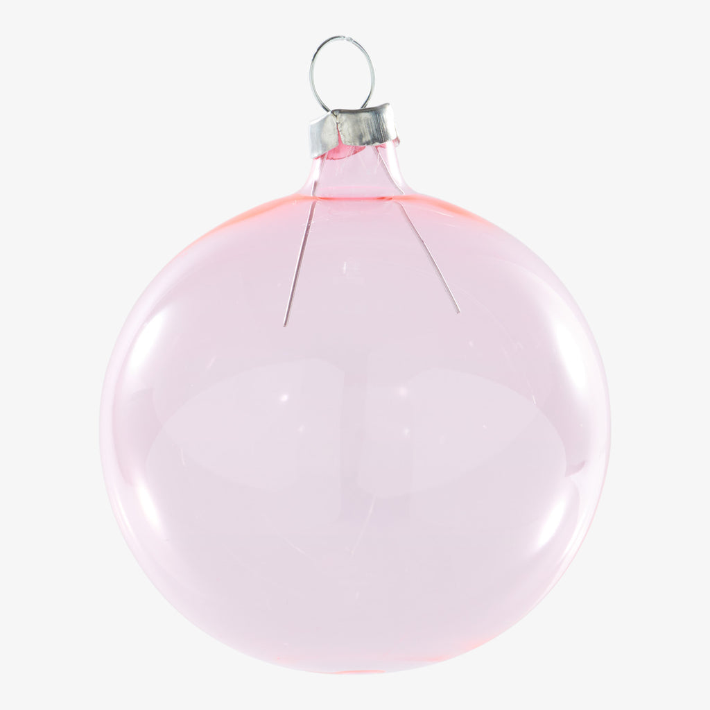 Translucent pink Christmas ornament with silver cap against white background.