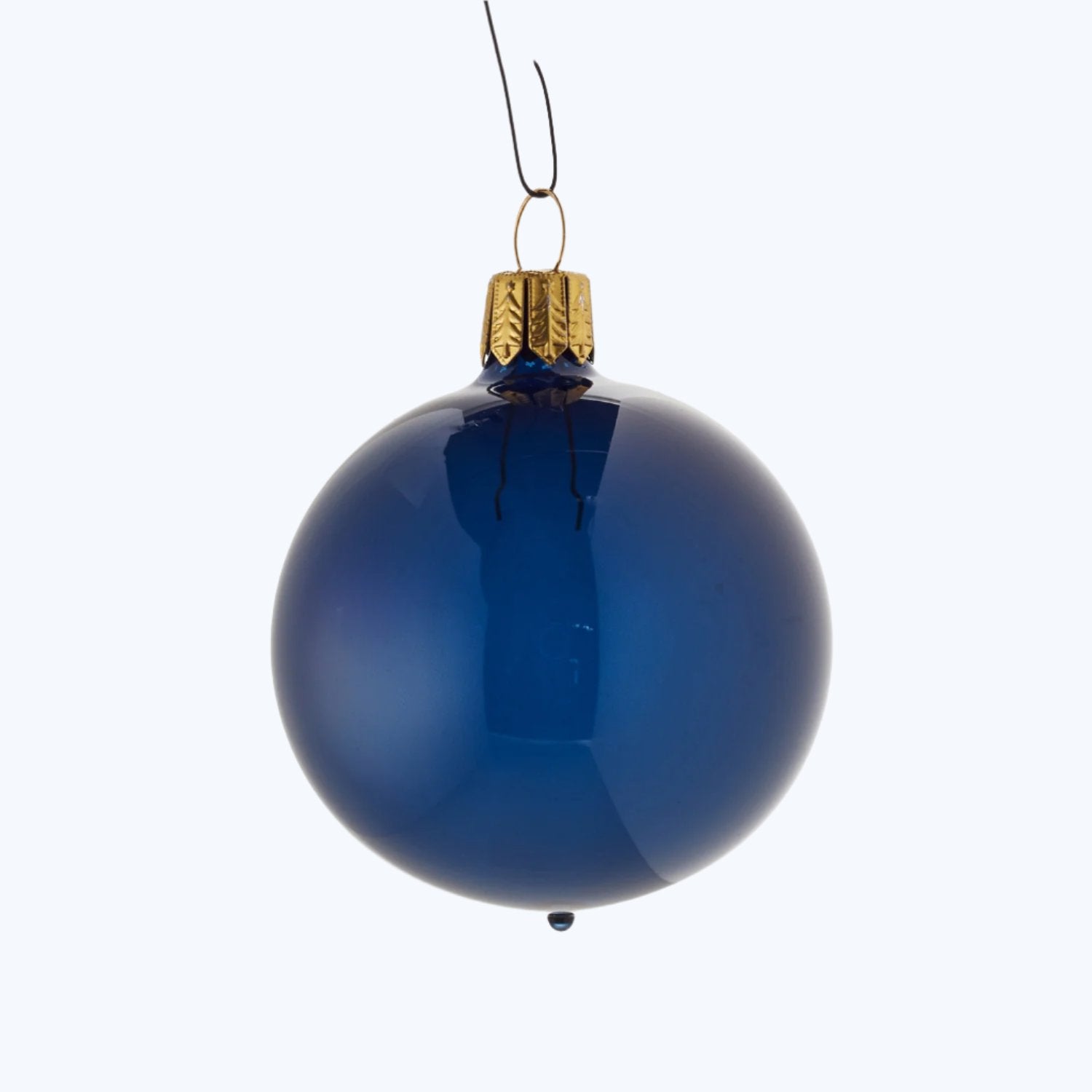 Single blue Christmas bauble with gold cap on white background.