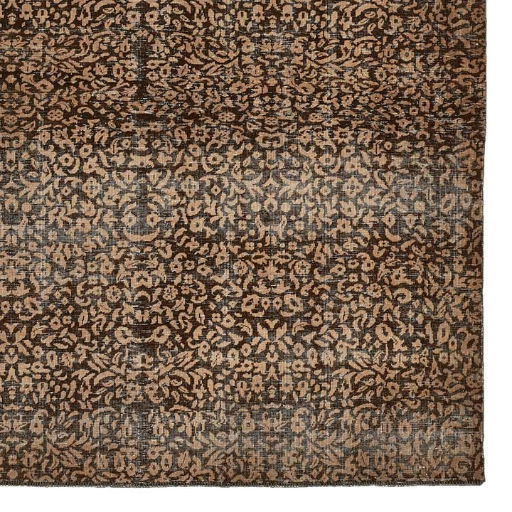 Intricate Oriental-style rug featuring floral motifs in faded vintage design.