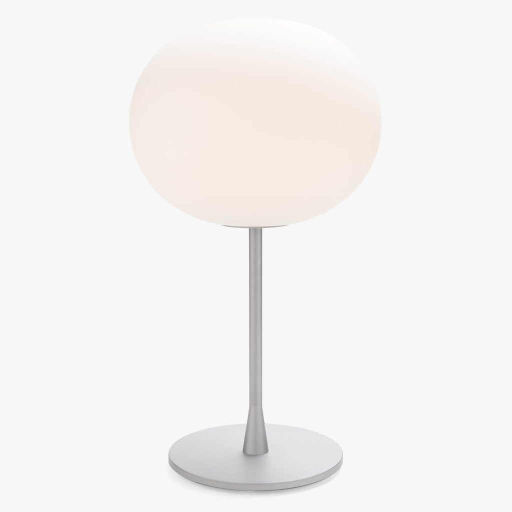 Modern minimalist table lamp with frosted glass diffuser and sleek metal stand.