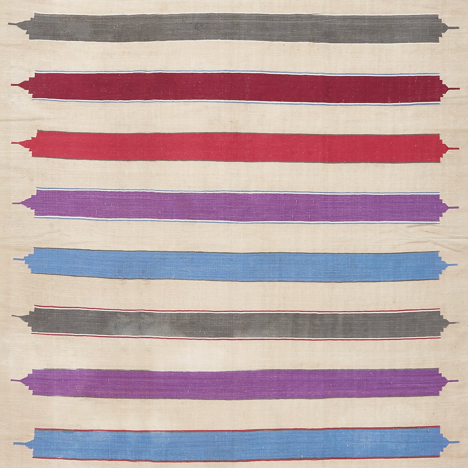 Textile with raw-edged, multi-colored stripes in varying widths and textures.