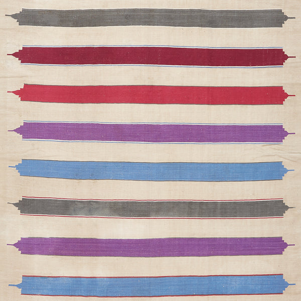 Textile with raw-edged, multi-colored stripes in varying widths and textures.