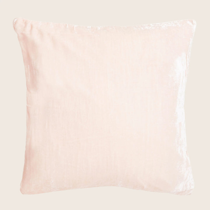 Soft, pale pink square pillow with crushed velvet texture.