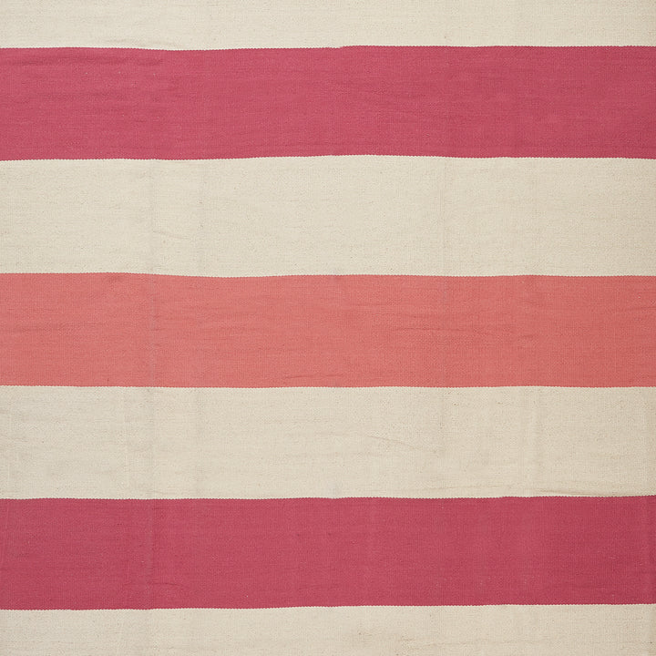 Handcrafted, minimalist textile with alternating cream and pink stripes.