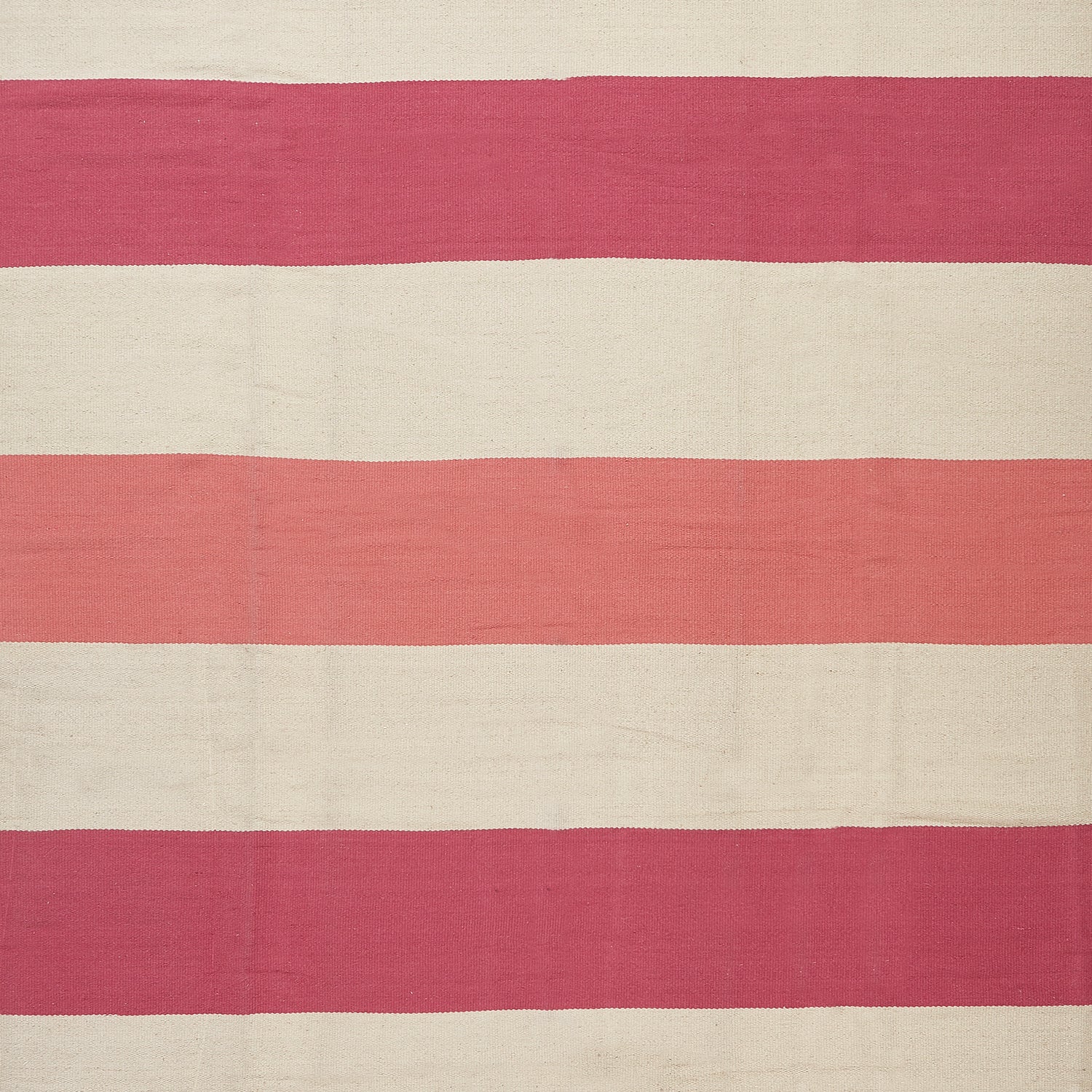 Handcrafted, minimalist textile with alternating cream and pink stripes.
