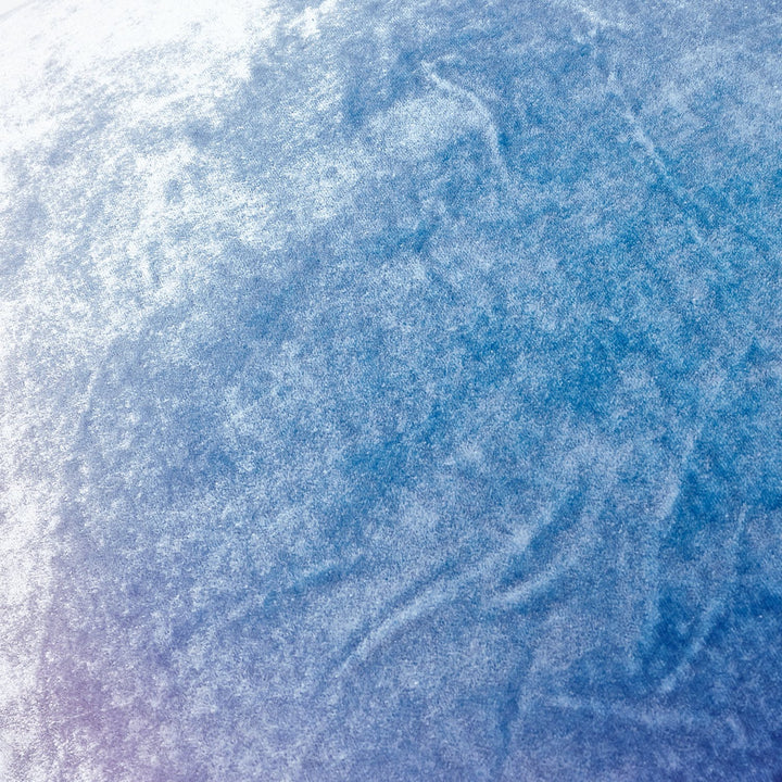 Close-up view of a textured, icy surface with blue tones.