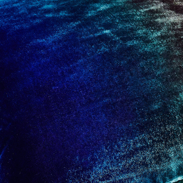 Captivating cosmic gradient of blues and blacks on textured surface.