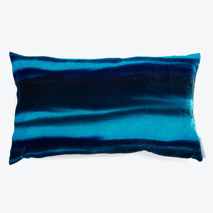 Vibrant blue rectangular pillow with gradient effect and plush texture.