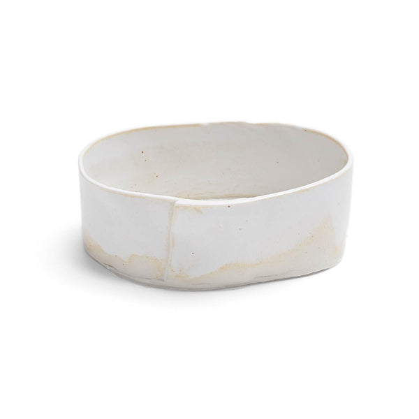 Versatile white ceramic dish, showing signs of use and wear.