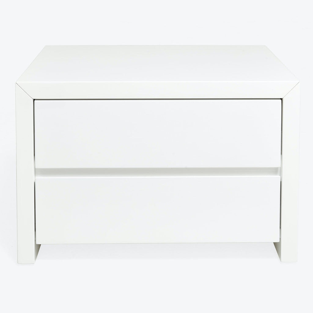 Minimalist white nightstand with sleek design and hidden drawers.