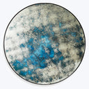Abstract blue and white pattern on round decorative object.