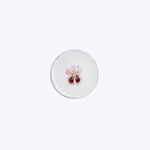 Minimalist round object with delicate pink flower illustration on top