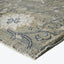 Close-up of an elegant and textured patterned rug with floral motifs.