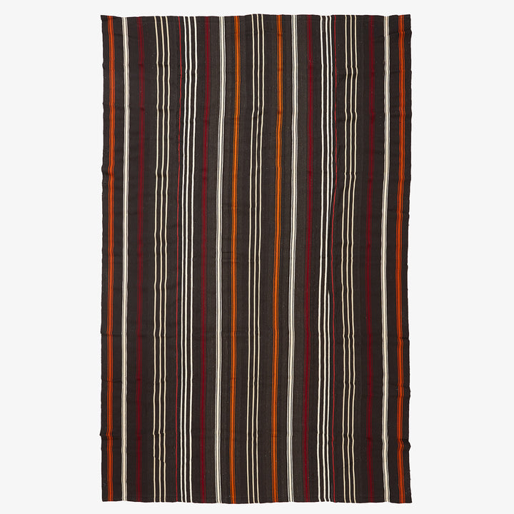 Vertical striped textile in dark hues with contrasting lighter stripes.