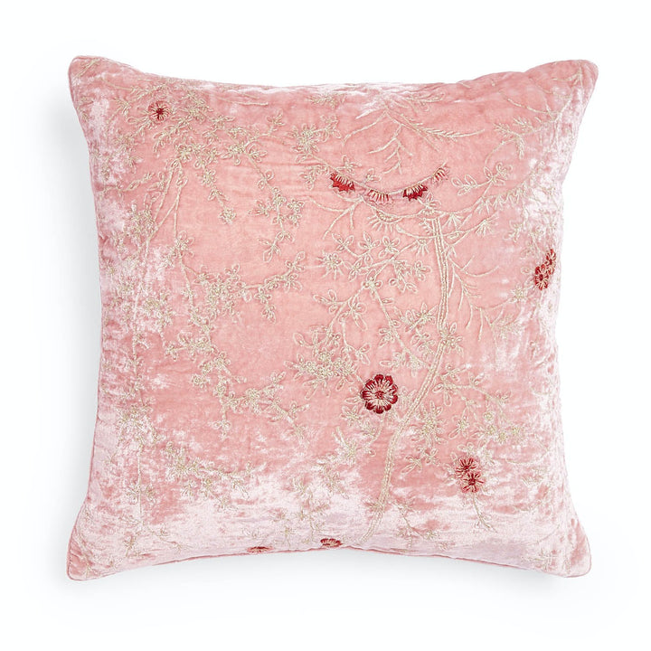 Soft and elegant decorative pillow with floral embroidery and plush texture.