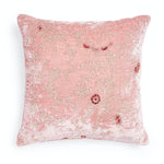 Soft and elegant decorative pillow with floral embroidery and plush texture.