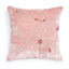Soft and elegant decorative pillow with floral embroidery and plush texture.
