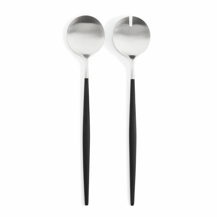 Modern salad servers featuring black handles and shiny metal utensils.