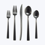Modern minimalist cutlery set with black handles and metallic finish