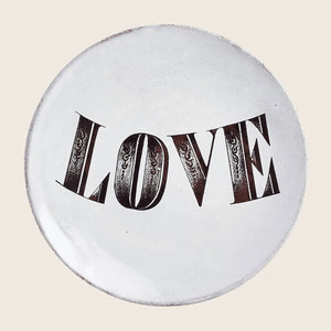 Ornate vintage LOVE badge with decorative elements on white background.