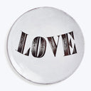 Ornate vintage LOVE badge with decorative elements on white background.