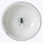 Handcrafted ceramic plate with insect design and white glaze surface.
