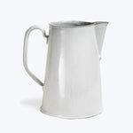 Vintage silver pitcher with handle and spout on white background.