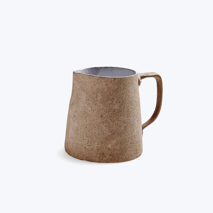 Rustic beige mug with handmade look, sturdy handle, and clean interior.