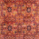 An antique Persian rug with intricate floral designs and warm hues.