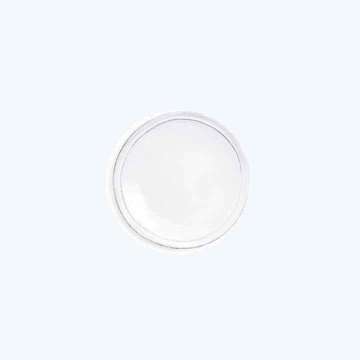 Plain white circular object with slight raised edge on background.