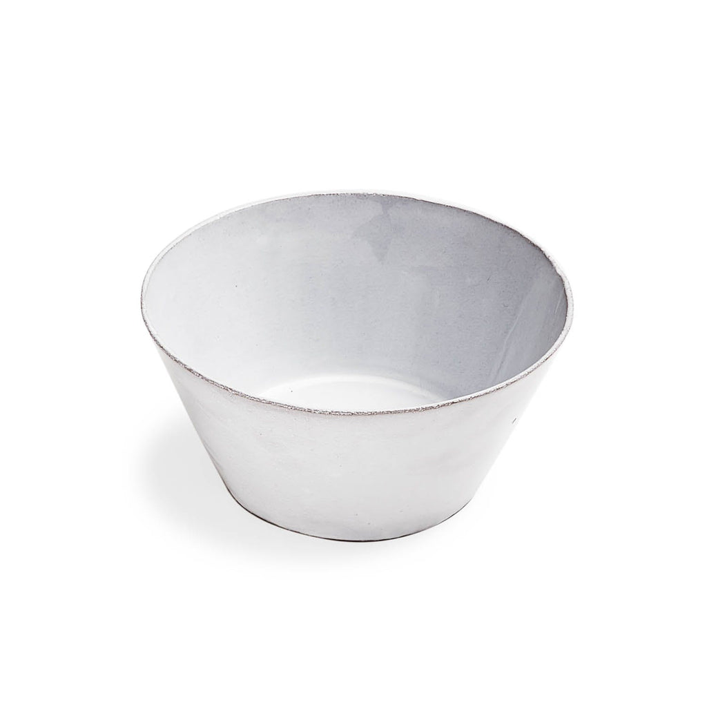A handcrafted white bowl with rustic texture and unfinished rim.