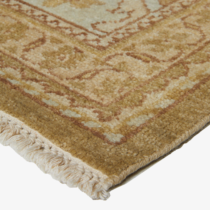 Close-up of a plush area rug with geometric pattern and fringe detail.