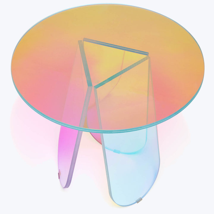 Modern coffee table with iridescent base and circular glass top.