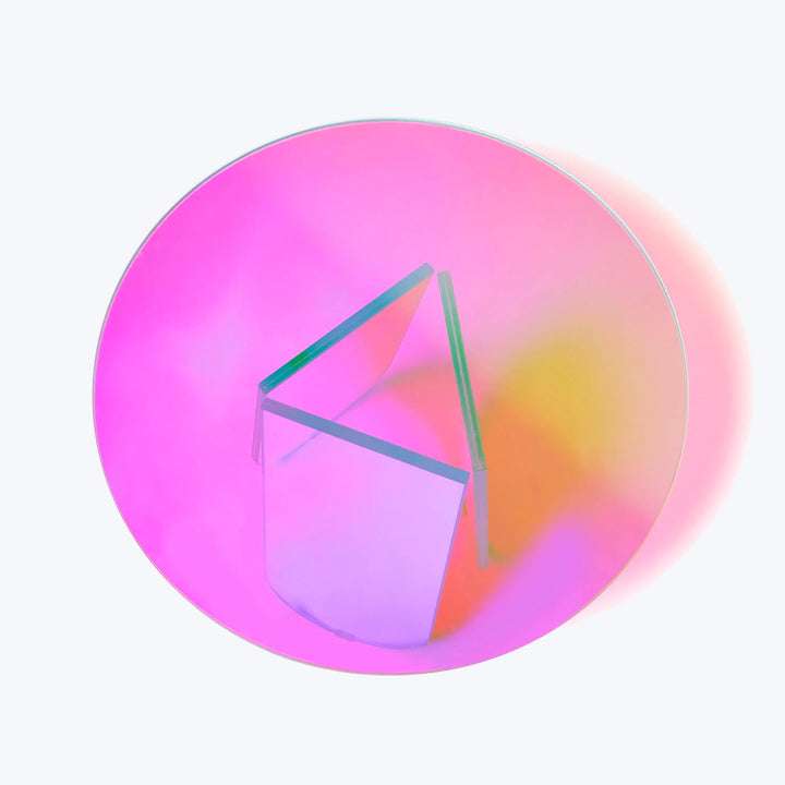 Modern art installation with prism structure against colorful gradient backdrop.