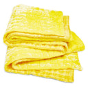 Folded yellow quilt showcases soft, textured design with plush stitched patterns.