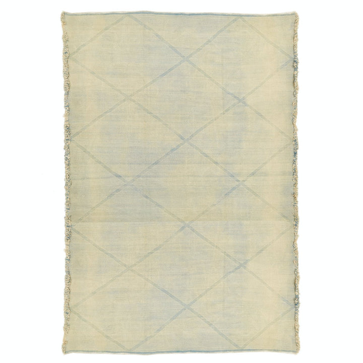 Rectangular rug with subtle diamond pattern and fringed edges