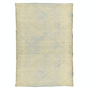 Rectangular rug with subtle diamond pattern and fringed edges