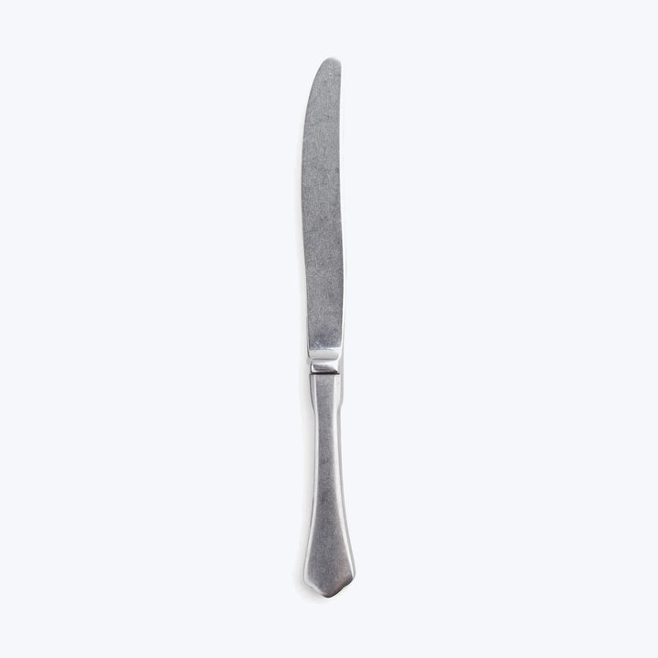 Table knife with ergonomic handle and matte finish isolated on white.