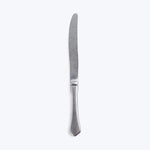 Table knife with ergonomic handle and matte finish isolated on white.