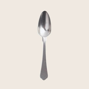 Single stainless steel spoon on white background, minimalist design, polished