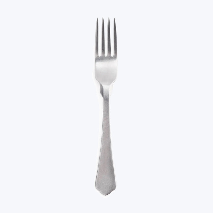 Minimalist image of a stainless steel fork on light background.