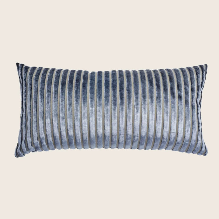 Decorative pillow with pleated design in varying shades of blue.
